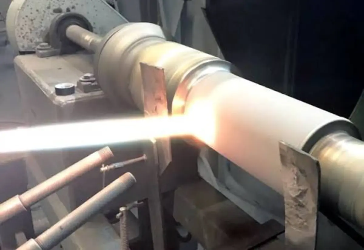 HVOF spray gun applying tungsten carbide coating