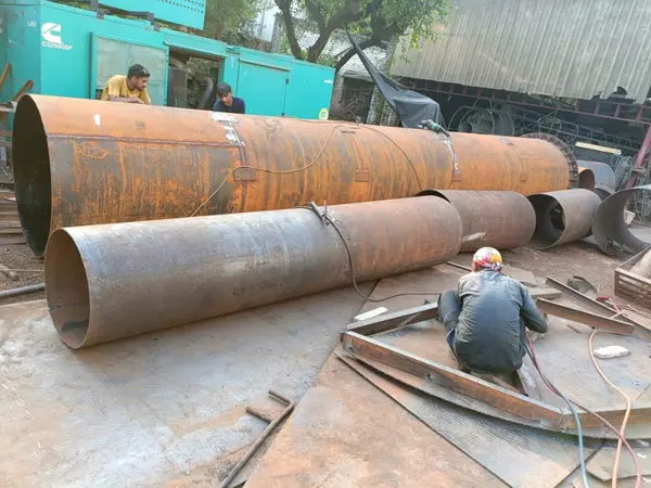 Chimney and duct sections under fabrication in the yard